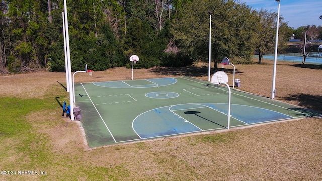 view of sport court featuring community basketball court and a lawn