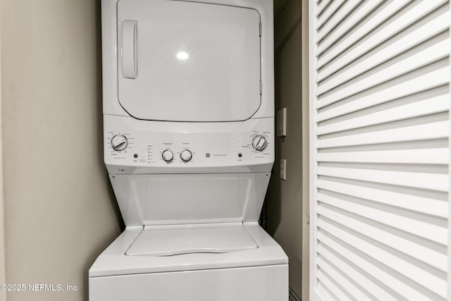 laundry area with stacked washer and dryer and laundry area