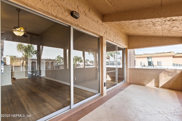 sunroom with lofted ceiling and ceiling fan