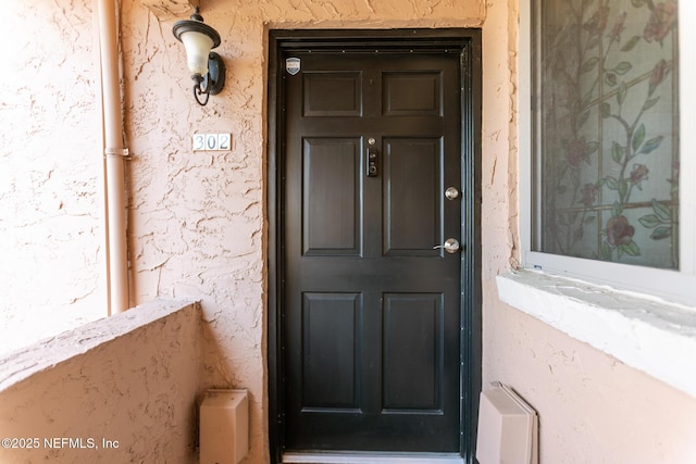 doorway to property with stucco siding