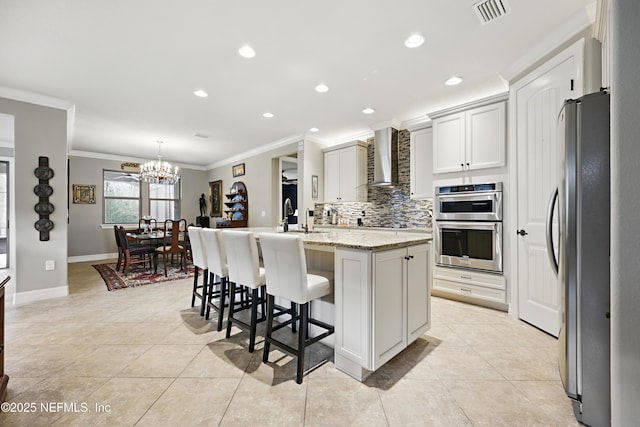 kitchen featuring stainless steel appliances, tasteful backsplash, visible vents, ornamental molding, and wall chimney exhaust hood