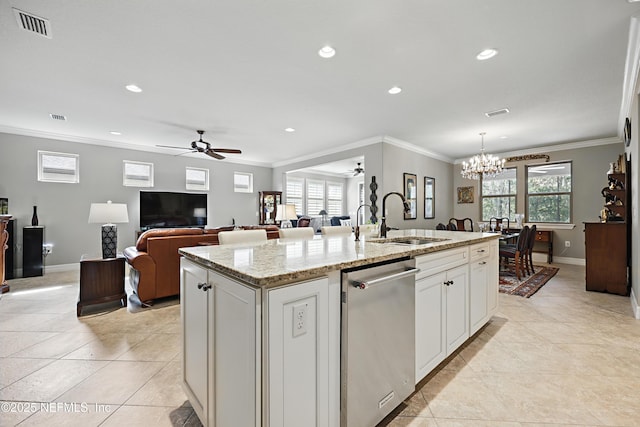 kitchen featuring visible vents, a kitchen island with sink, crown molding, stainless steel dishwasher, and a sink