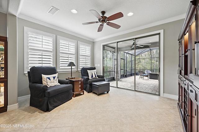 living area featuring visible vents, baseboards, a sunroom, and crown molding