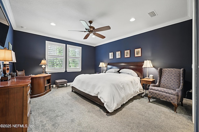 bedroom featuring visible vents, ornamental molding, a ceiling fan, carpet flooring, and baseboards