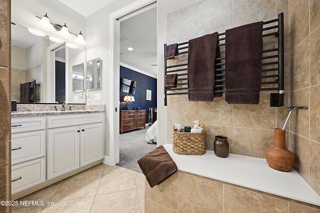 ensuite bathroom featuring ensuite bathroom, ornamental molding, vanity, and tile patterned floors