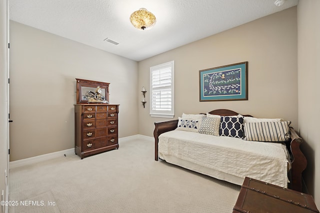 bedroom featuring carpet floors, baseboards, visible vents, and a textured ceiling