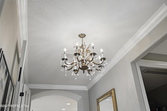 interior details featuring a notable chandelier and crown molding