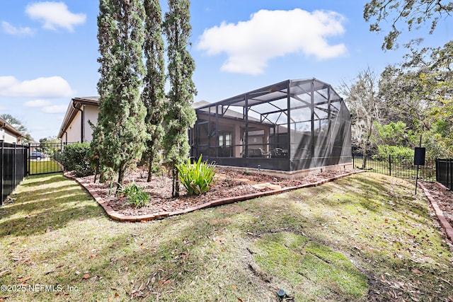 view of yard featuring a fenced backyard and a lanai