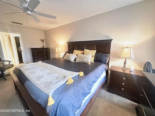 bedroom with light carpet, a ceiling fan, visible vents, and a textured ceiling