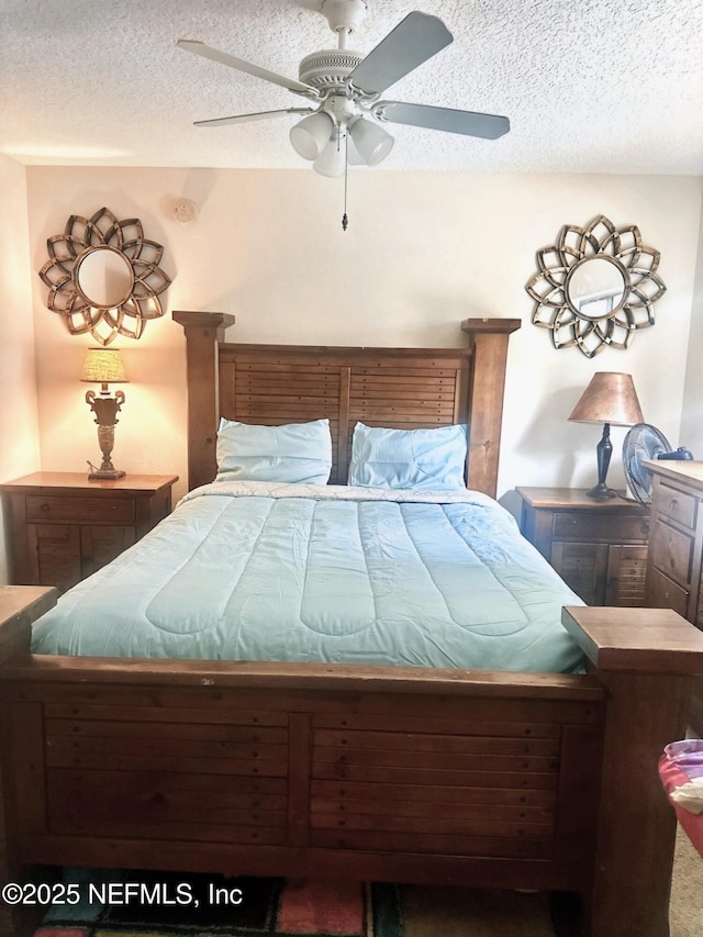 bedroom with a textured ceiling and ceiling fan