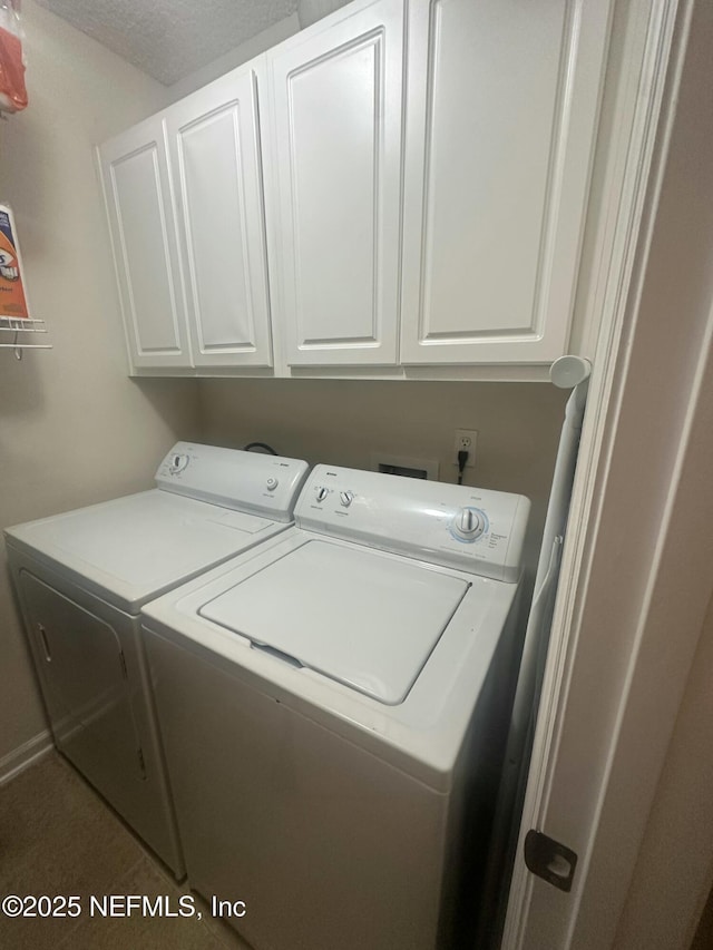 laundry area with washing machine and dryer and cabinet space