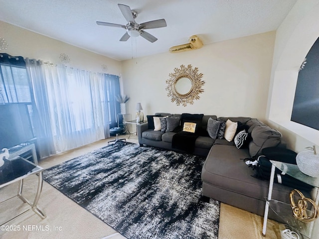 carpeted living room with ceiling fan and a textured ceiling