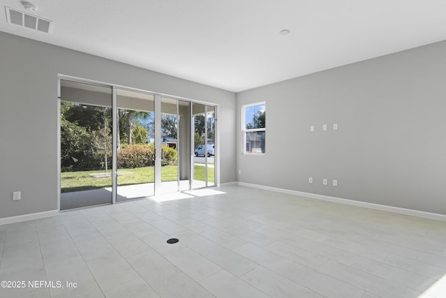 empty room featuring baseboards and visible vents