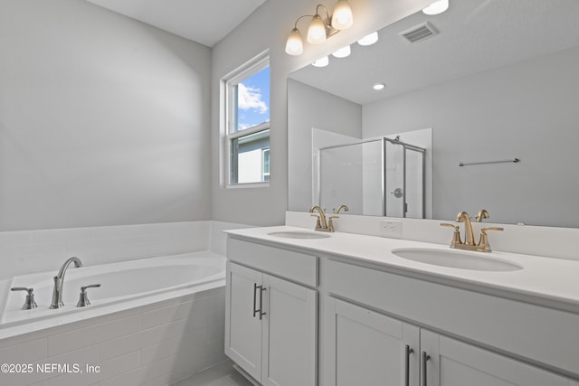 full bath with double vanity, a sink, visible vents, and a shower stall