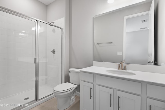 bathroom featuring a stall shower, vanity, and toilet