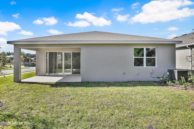 back of house with a patio, central AC, a shingled roof, a lawn, and stucco siding