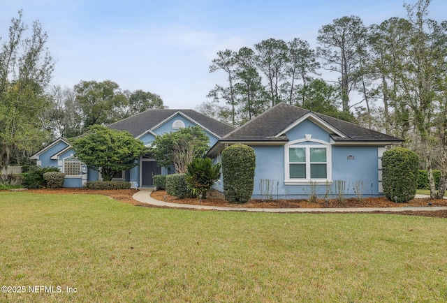 ranch-style home with a front lawn and stucco siding