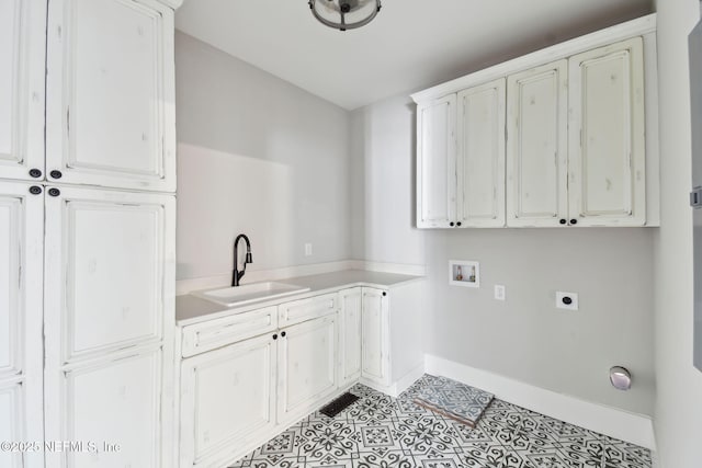 clothes washing area with washer hookup, a sink, baseboards, cabinet space, and electric dryer hookup