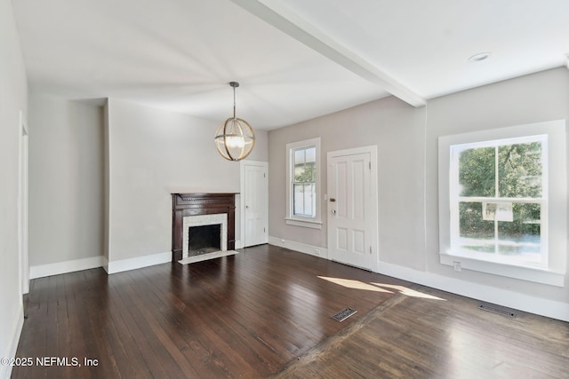 unfurnished living room with beam ceiling, visible vents, dark wood-type flooring, a fireplace with flush hearth, and baseboards