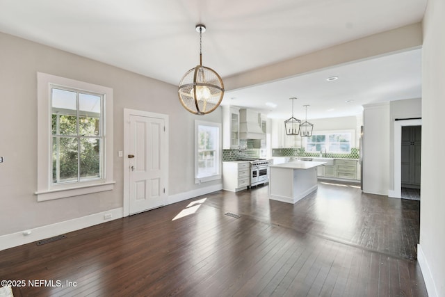 kitchen featuring visible vents, double oven range, a center island, dark wood-style floors, and custom range hood