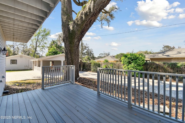 wooden deck with fence and a patio