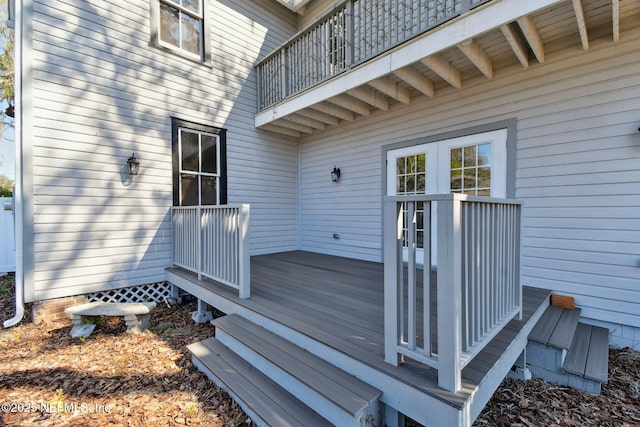 doorway to property with a deck and a balcony