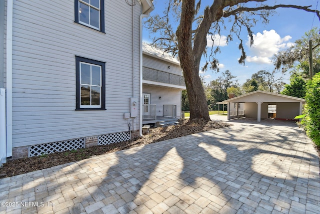 view of side of home featuring a detached carport and crawl space