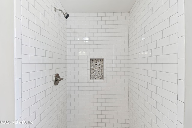 full bath featuring tiled shower