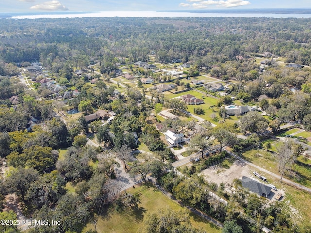 drone / aerial view featuring a residential view and a view of trees