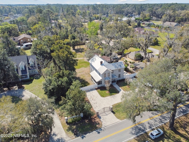 aerial view featuring a wooded view