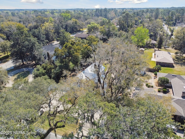 bird's eye view with a wooded view