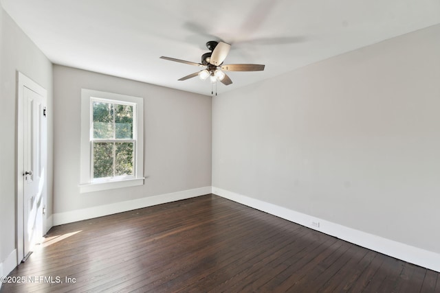 unfurnished room with dark wood-style floors, baseboards, and a ceiling fan