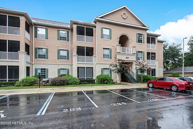 view of building exterior featuring uncovered parking