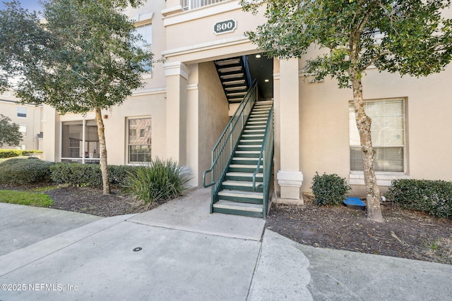 doorway to property featuring stucco siding