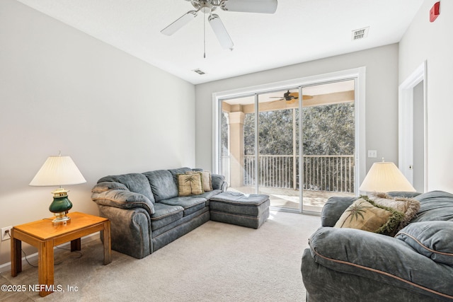 living area featuring ceiling fan, carpet floors, and visible vents