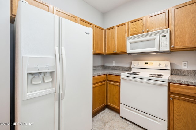 kitchen with white appliances and light tile patterned flooring