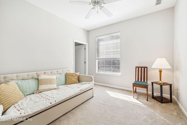 carpeted living room with a ceiling fan, visible vents, and baseboards