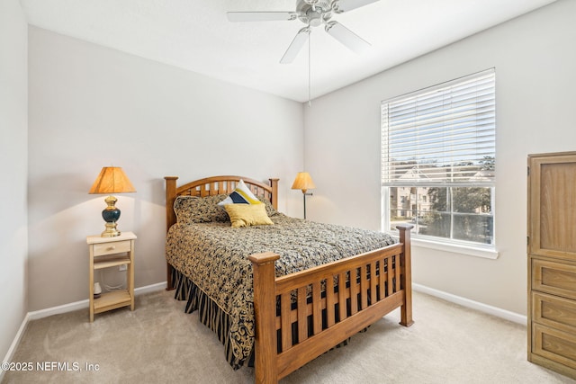 bedroom featuring light carpet, ceiling fan, and baseboards