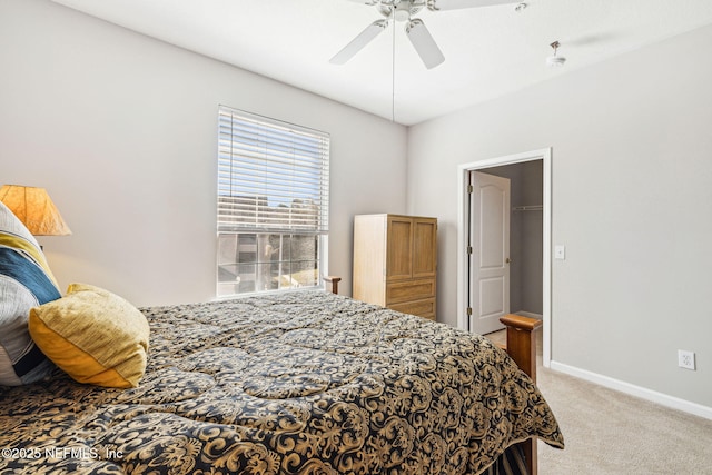 bedroom featuring light carpet, a ceiling fan, and baseboards