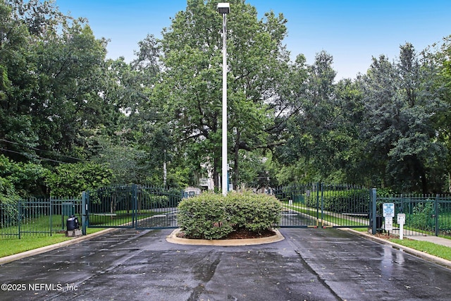 view of community with a gate and fence