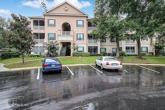 view of property featuring uncovered parking