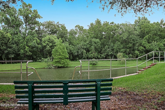 view of home's community featuring a water view and a lawn