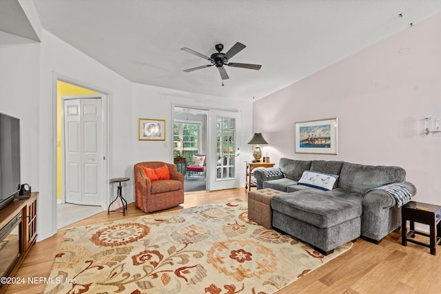 living area with ceiling fan, vaulted ceiling, and wood finished floors