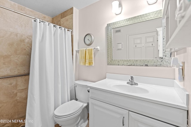 full bath with visible vents, a tile shower, vanity, and toilet