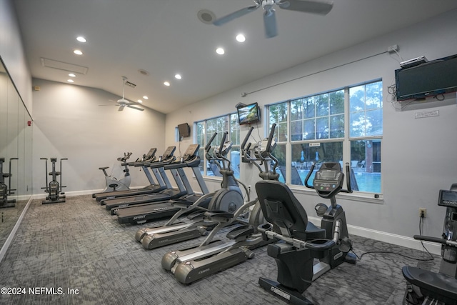 gym with vaulted ceiling, carpet floors, ceiling fan, and baseboards