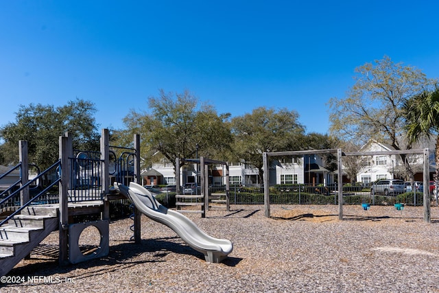 community playground featuring a residential view and fence