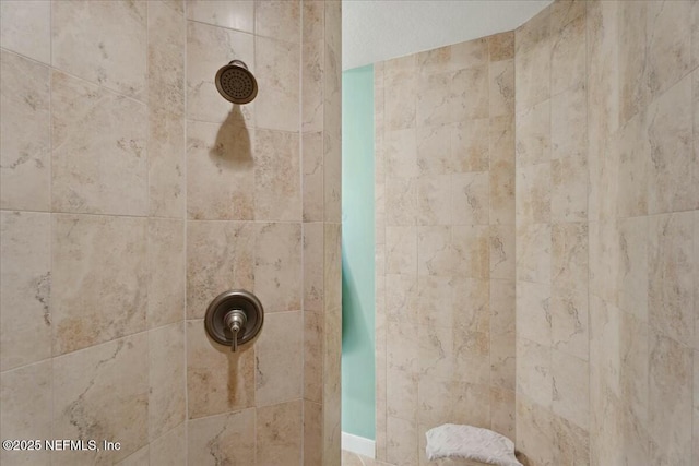 full bath with a tile shower