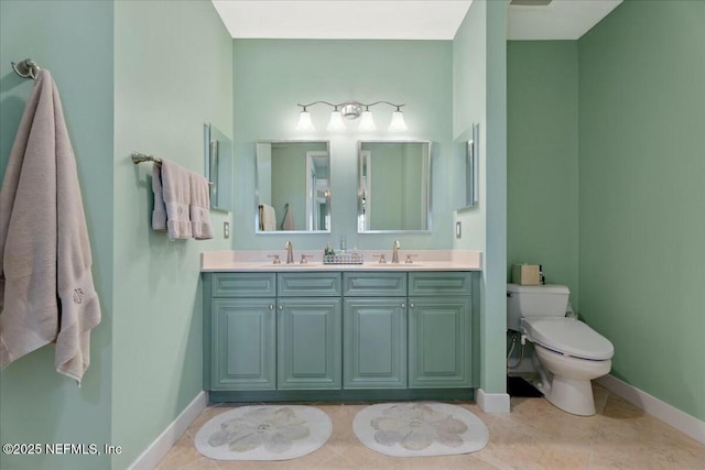 full bath with tile patterned floors, double vanity, toilet, and a sink