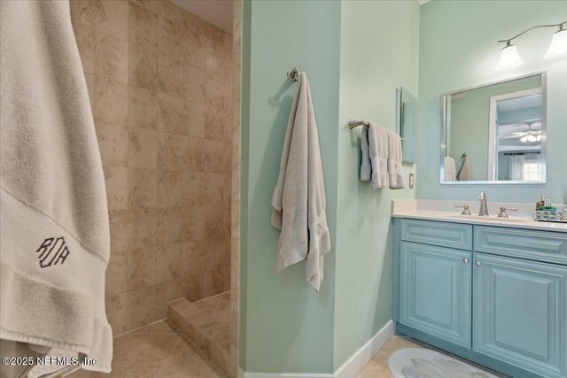 full bathroom with vanity, a walk in shower, baseboards, and tile patterned flooring