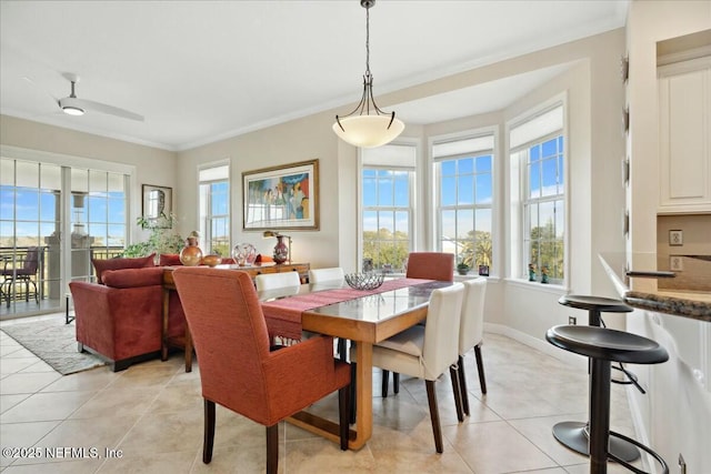 dining room featuring light tile patterned flooring, baseboards, and ornamental molding